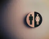 Symbol płci na tle ściany. Fizjoterapia uroginekologiczna dla każdego.